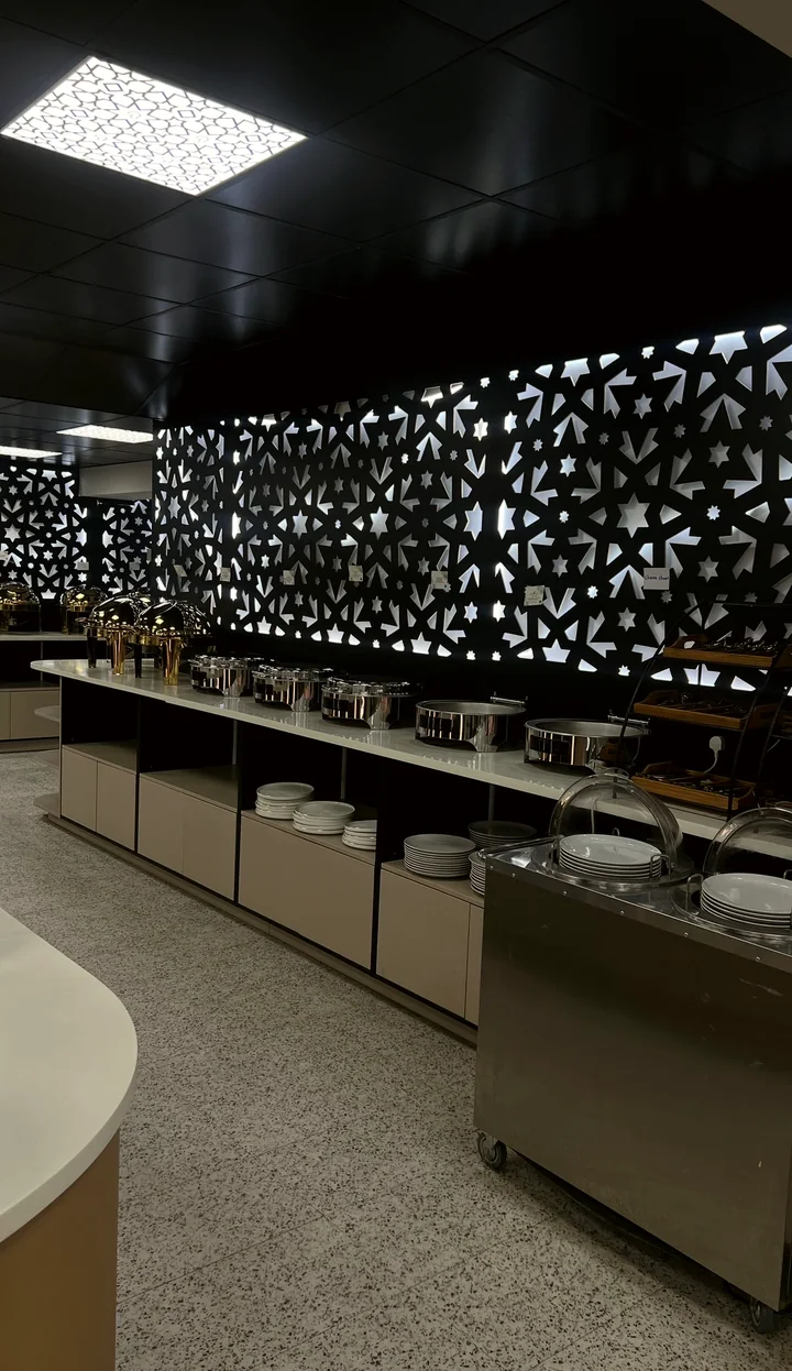 The buffet counter in front of a lit geometric screen